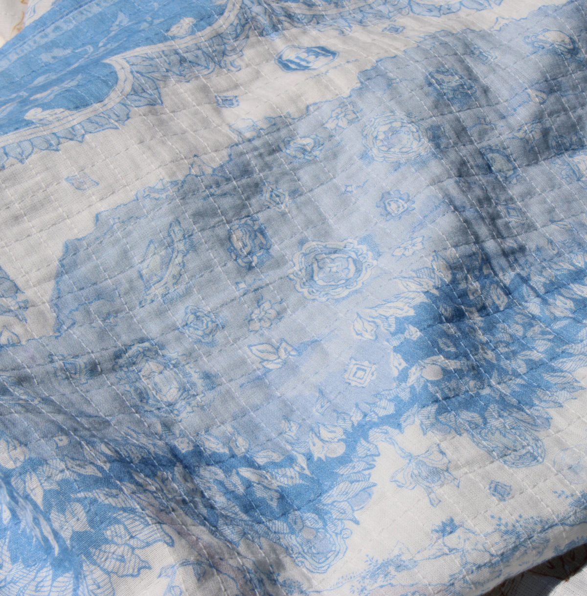 Close-up of indigo toile print on cotton muslin baby blanket